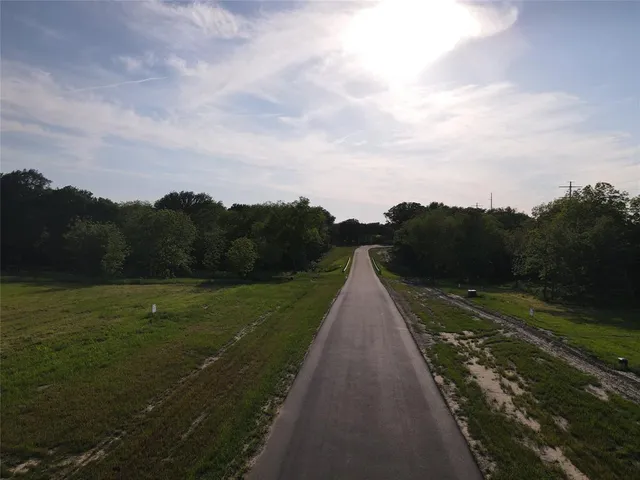 a view of a street with a yard