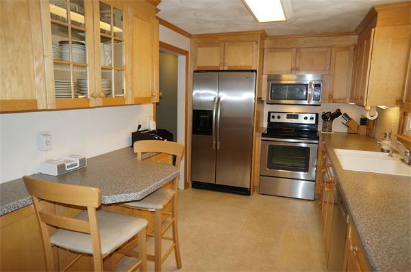 20 Sudbury Road Stow, MA 01775 - Photo 4 of 12 a kitchen with stainless steel appliances granite countertop a sink a stove and a refrigerator