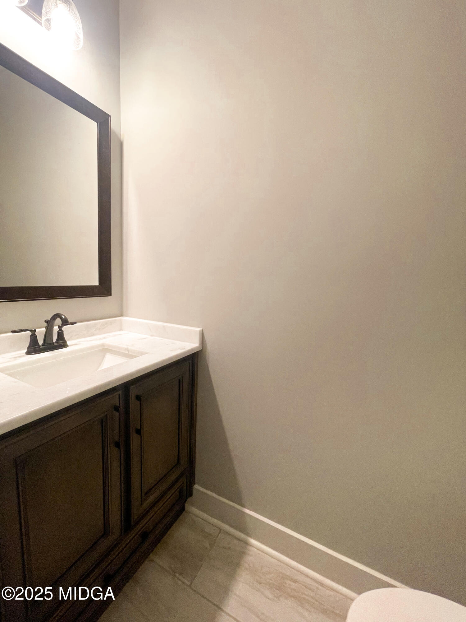 113 Perth Court Warner Robins, GA 31088 - Photo 26 of 28 a bathroom with a sink and a mirror