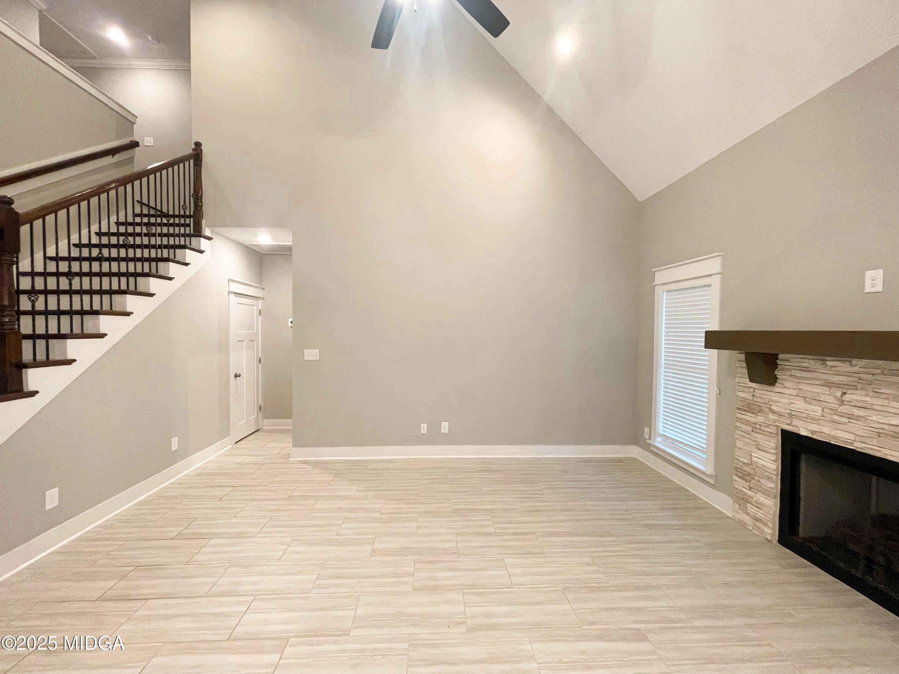 113 Perth Court Warner Robins, GA 31088 - Photo 5 of 28 a view of an empty room with wooden floor and a fireplace