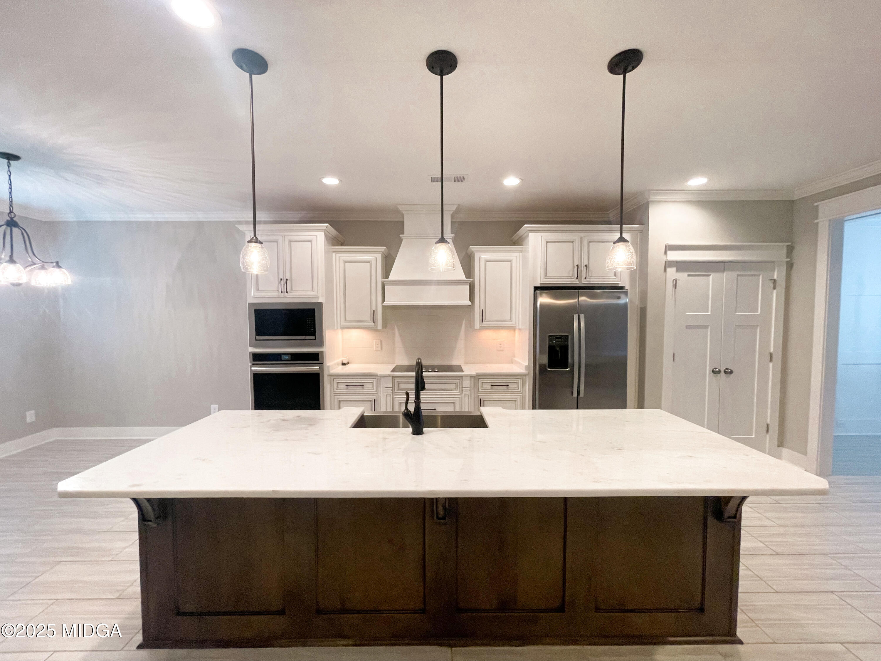 113 Perth Court Warner Robins, GA 31088 - Photo 7 of 28 a kitchen with kitchen island a sink stainless steel appliances and chairs