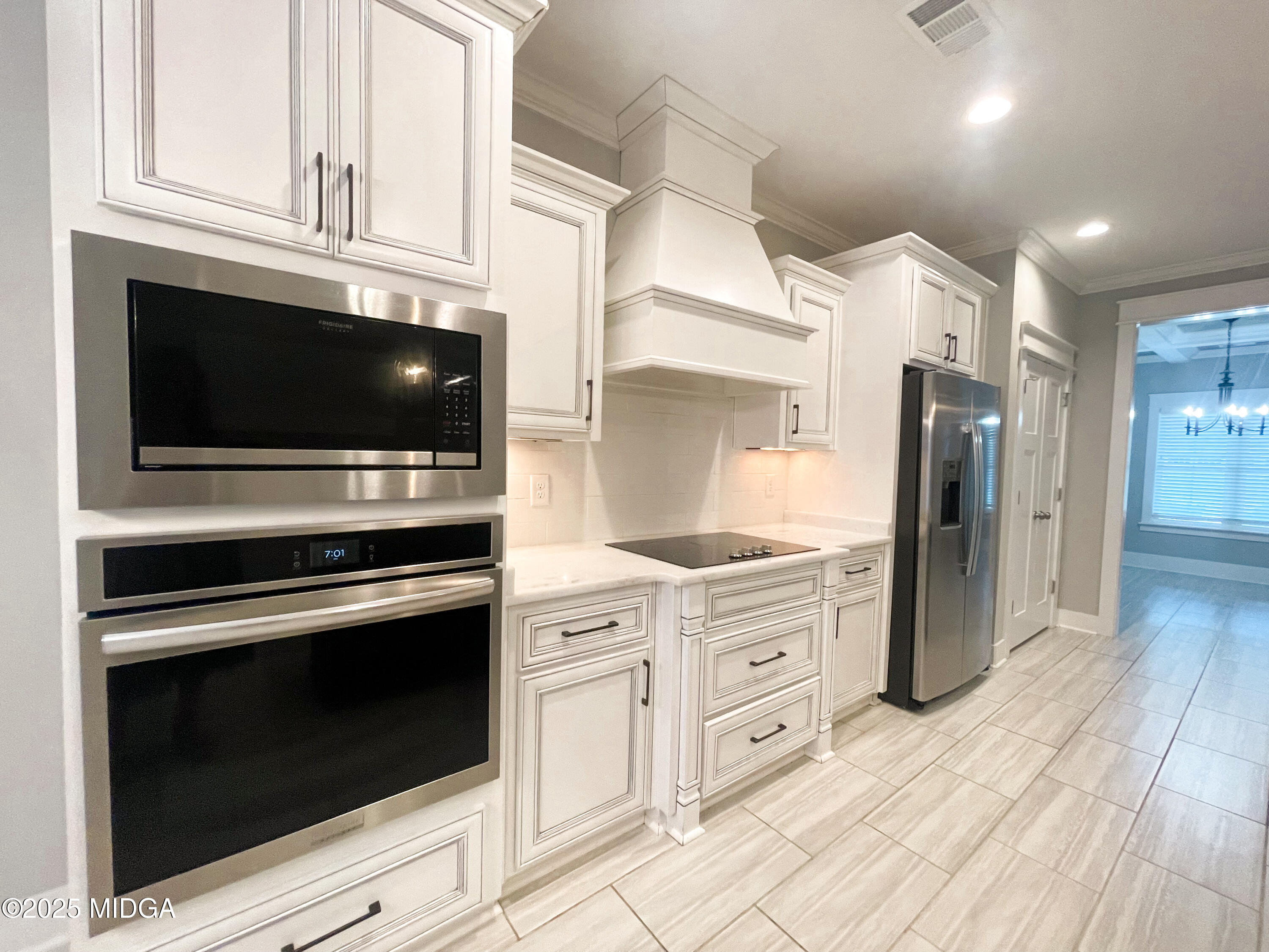 113 Perth Court Warner Robins, GA 31088 - Photo 8 of 28 a kitchen with stainless steel appliances white cabinets and a stove top oven