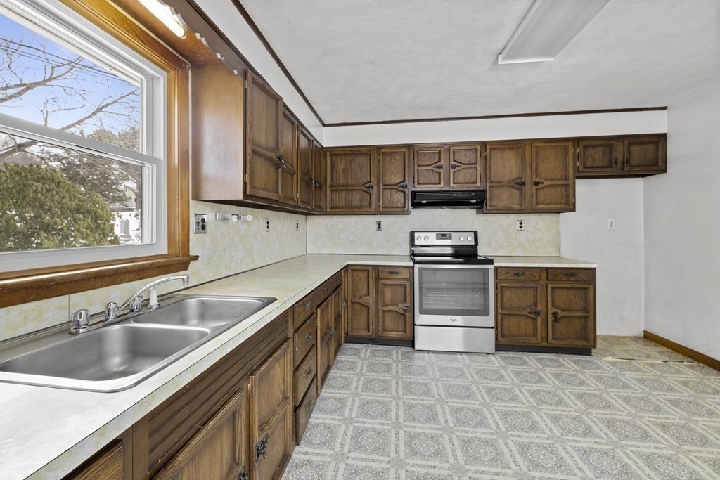 44 Sumner Street Gloucester, MA 01930 - Photo 11 of 40 a kitchen with stainless steel appliances a stove a sink and a microwave
