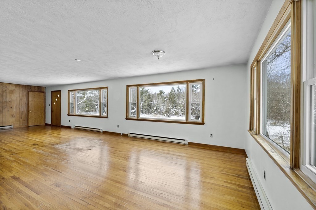 44 Sumner Street Gloucester, MA 01930 - Photo 13 of 40 a view of an empty room with wooden floor and a window