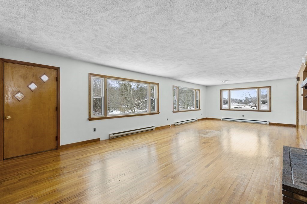 44 Sumner Street Gloucester, MA 01930 - Photo 16 of 40 an empty room with wooden floor and windows