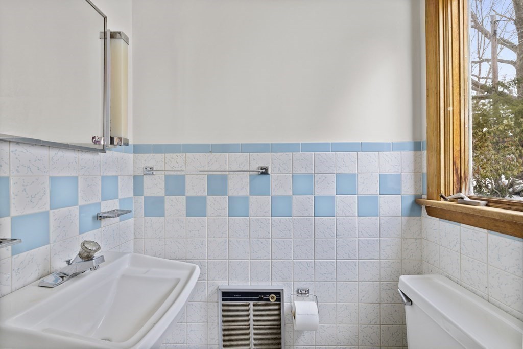 44 Sumner Street Gloucester, MA 01930 - Photo 29 of 40 a bathroom with a sink a toilet and a mirror