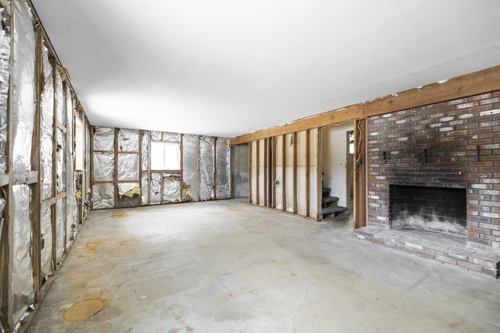 44 Sumner Street Gloucester, MA 01930 - Photo 31 of 40 a view of an empty room with a fireplace and windows