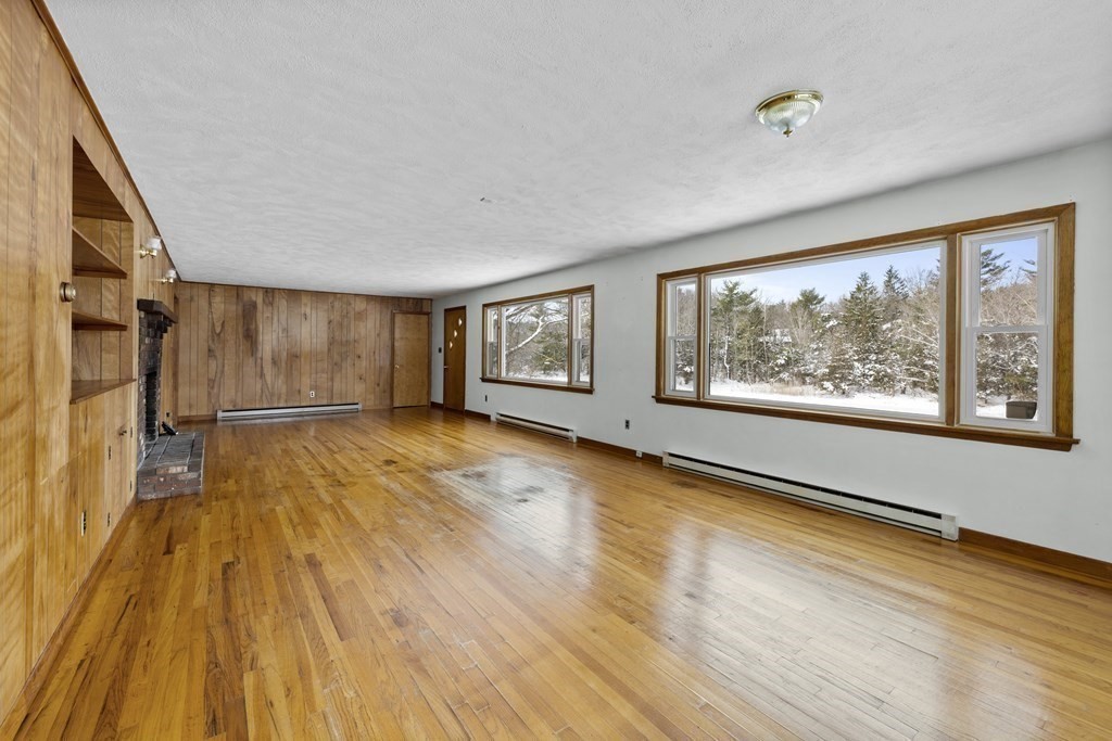 44 Sumner Street Gloucester, MA 01930 - Photo 5 of 40 a view of an empty room with a window and wooden floor
