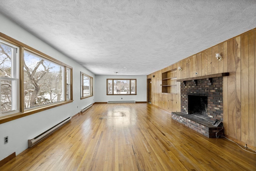 44 Sumner Street Gloucester, MA 01930 - Photo 6 of 40 wooden floor fireplace and windows in an empty room