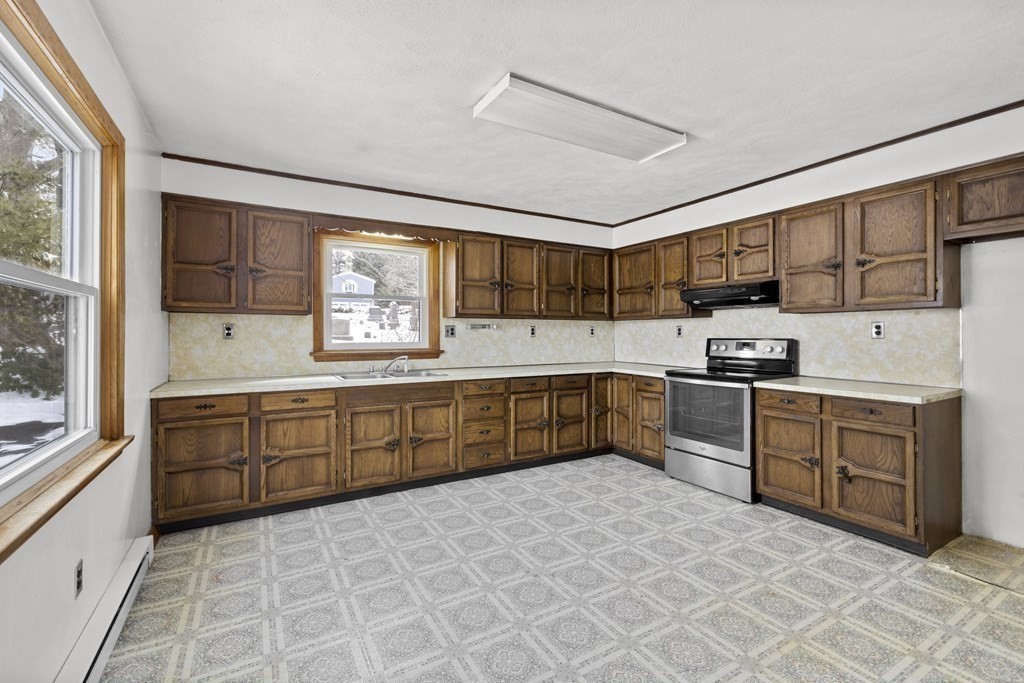 44 Sumner Street Gloucester, MA 01930 - Photo 10 of 40 a kitchen with stainless steel appliances granite countertop a stove sink and cabinets