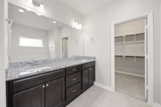 a bathroom with a granite countertop sink two mirror and a