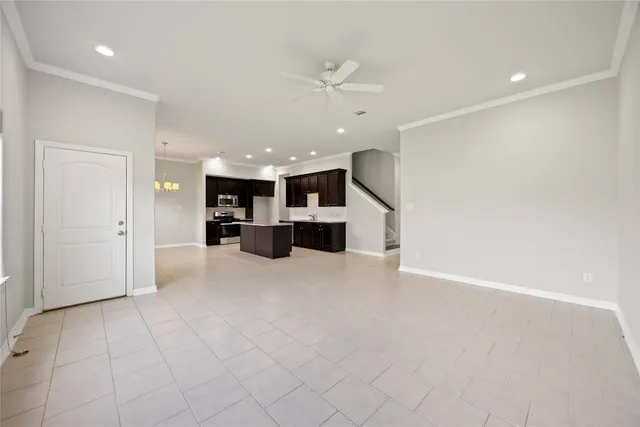 an open kitchen with a sink and a stove top oven