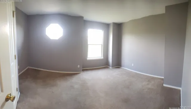 an empty room with windows and closet