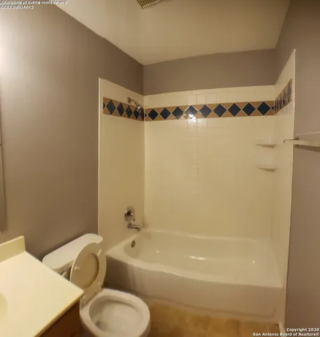 a bathroom with a tub a sink and a shower