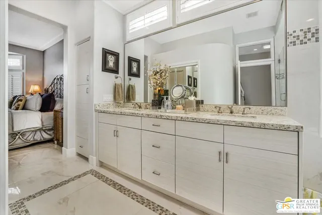a en suite bathroom with double sink and a mirror