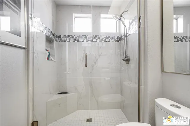 a bathroom with a shower and toilet