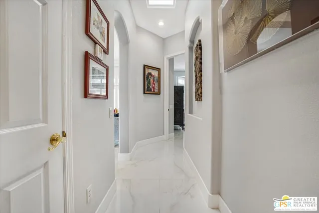 a view of a hallway with paintings on the wall