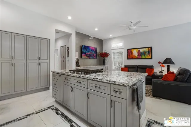 a open kitchen with stainless steel appliances granite countertop a stove and a sink