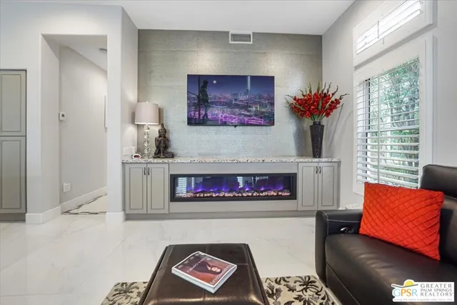 a picture of a living room with furniture and a gate