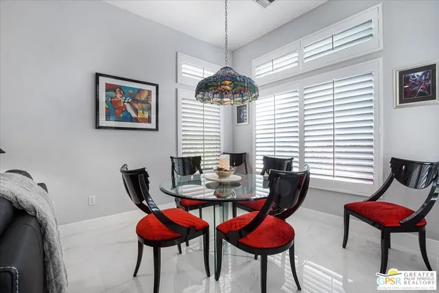 a view of a dining room with furniture and a chandelier