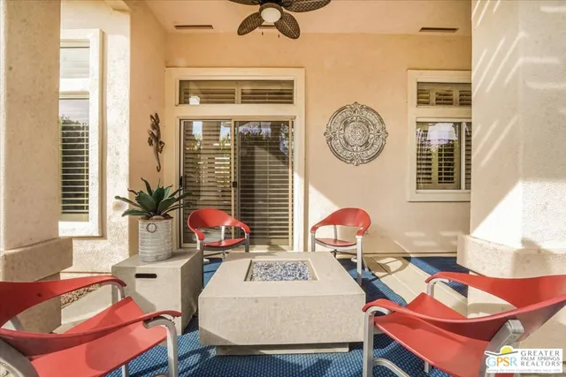 a view of a house with a yard and sitting area