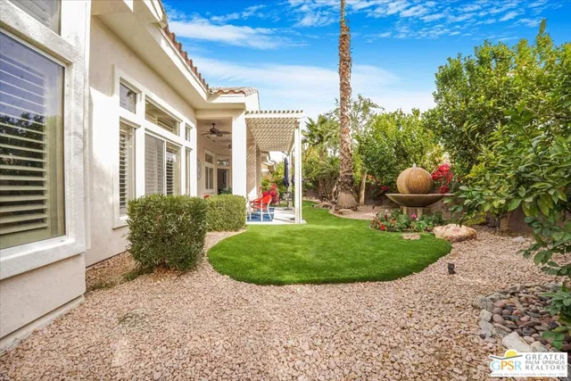 a front view of a house with yard and outdoor seating