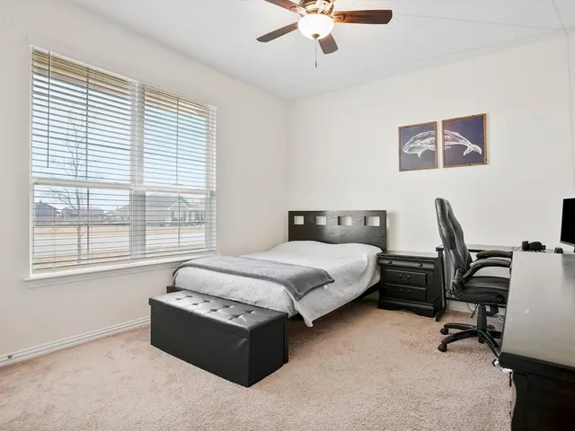 a spacious bedroom with a bed and a desk