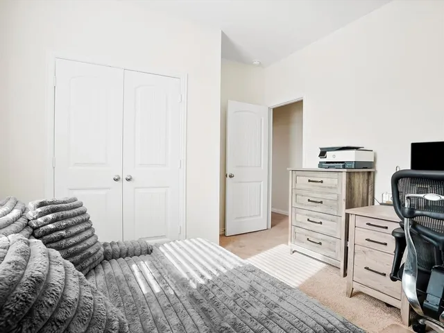 a bedroom with a bed and a cabinets