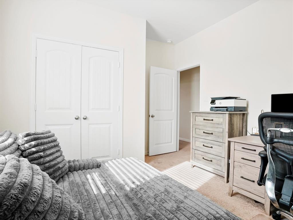 173 Mdw Vista Drive Rhome, TX 76078 - Photo 23 of 40 a bedroom with a bed and a cabinets