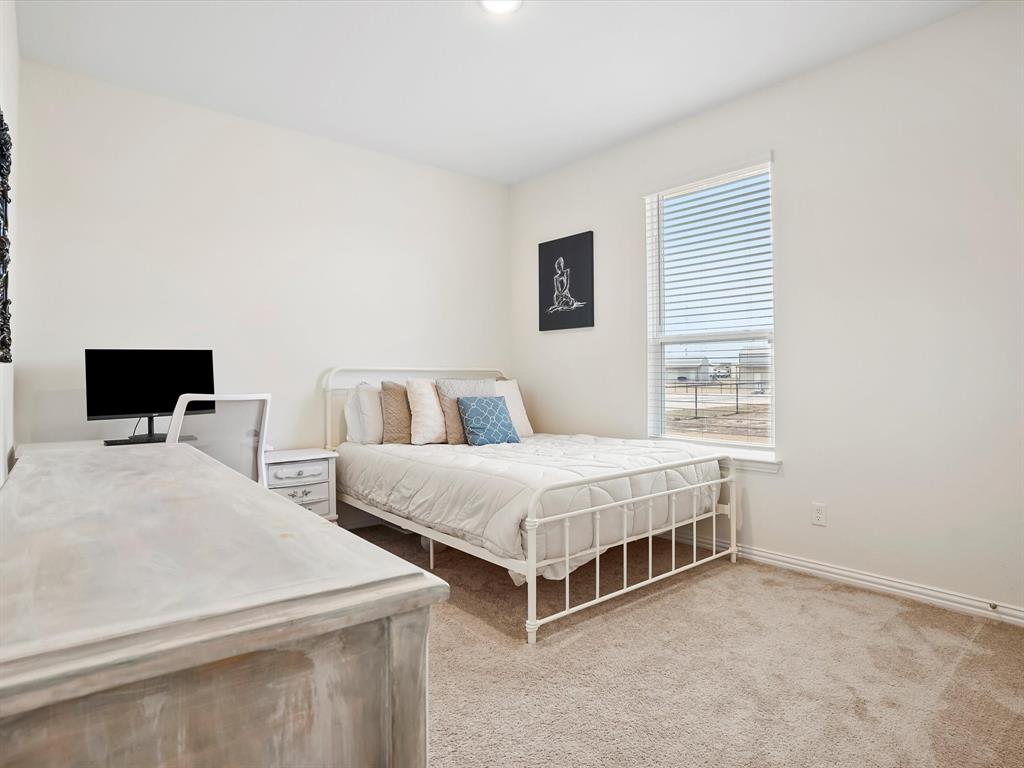 173 Mdw Vista Drive Rhome, TX 76078 - Photo 25 of 40 a bedroom with two beds and a window
