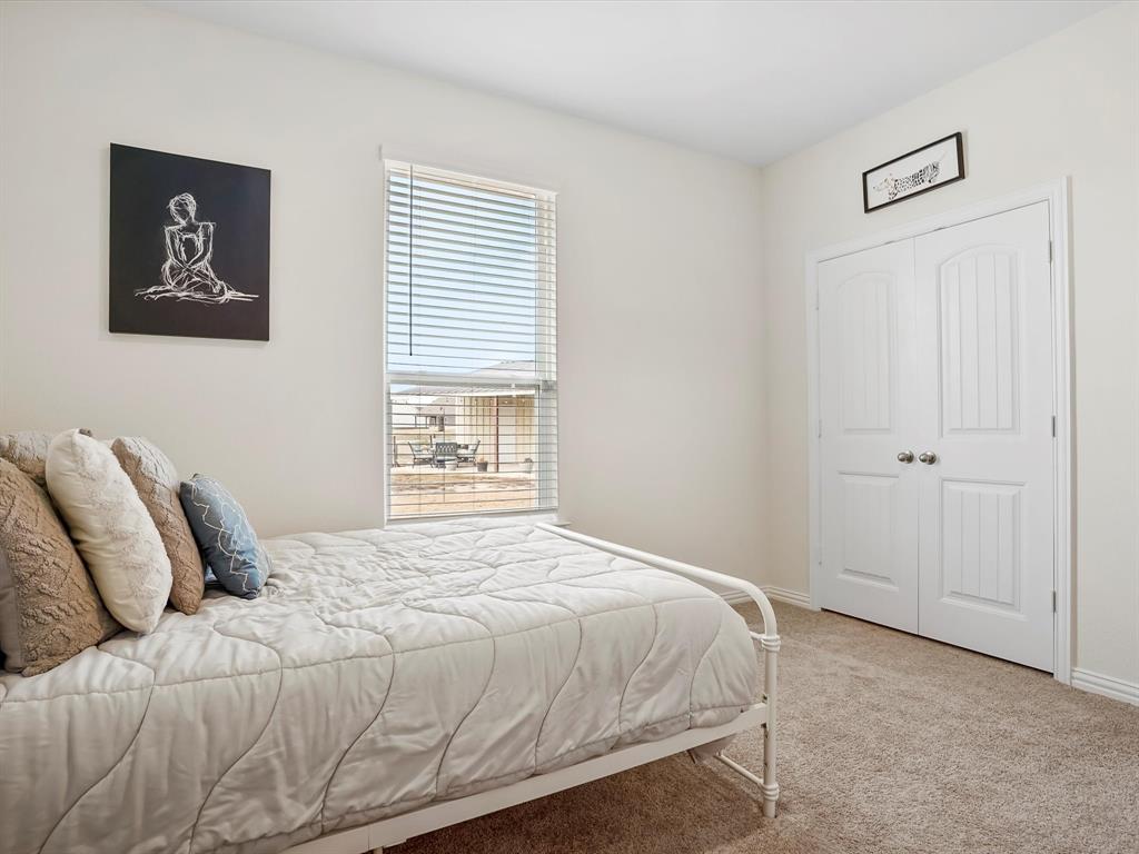 173 Mdw Vista Drive Rhome, TX 76078 - Photo 26 of 40 a bedroom with a bed and a window