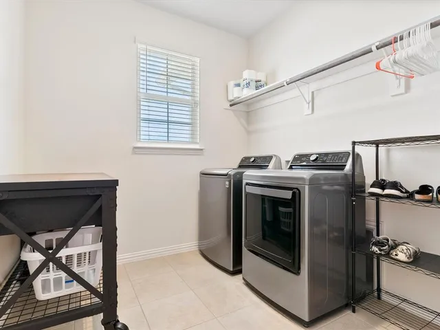 a utility room with closet dryer and washer