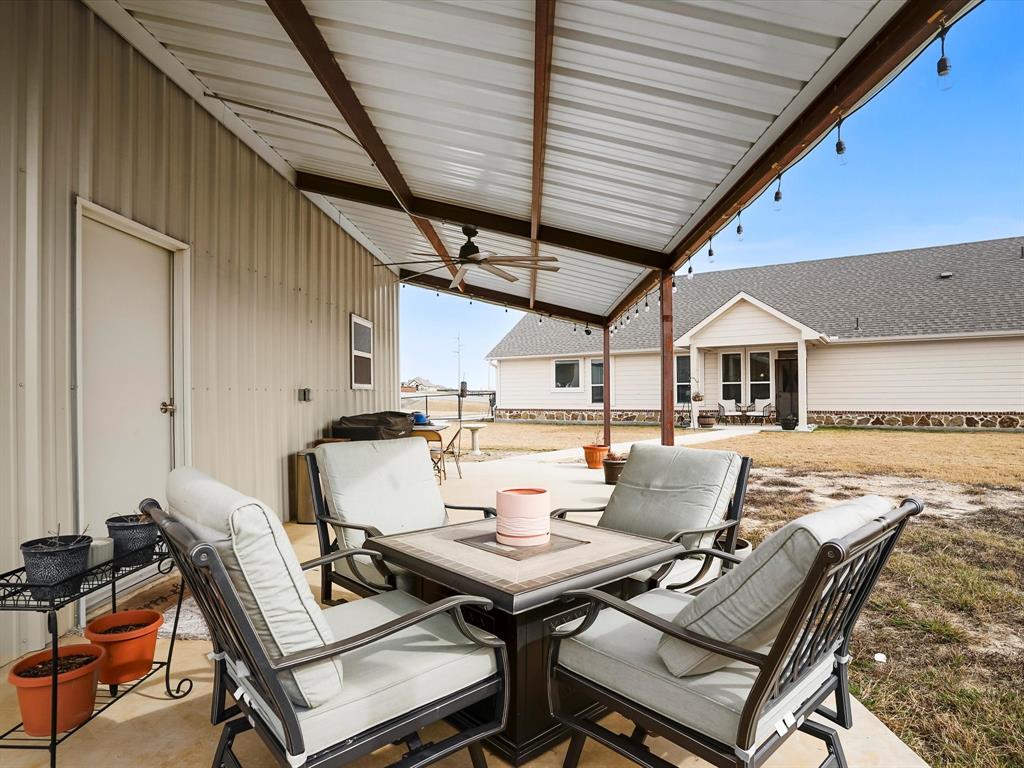 173 Mdw Vista Drive Rhome, TX 76078 - Photo 35 of 40 a roof deck with a dining table and chairs with wooden floor