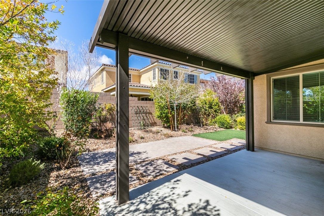 2549 Sable Ridge Street Henderson, NV 89044 - Photo 4 of 8 A well-designed patio with a covered section opens to a landscaped yard with mature plantings and stepping stones.