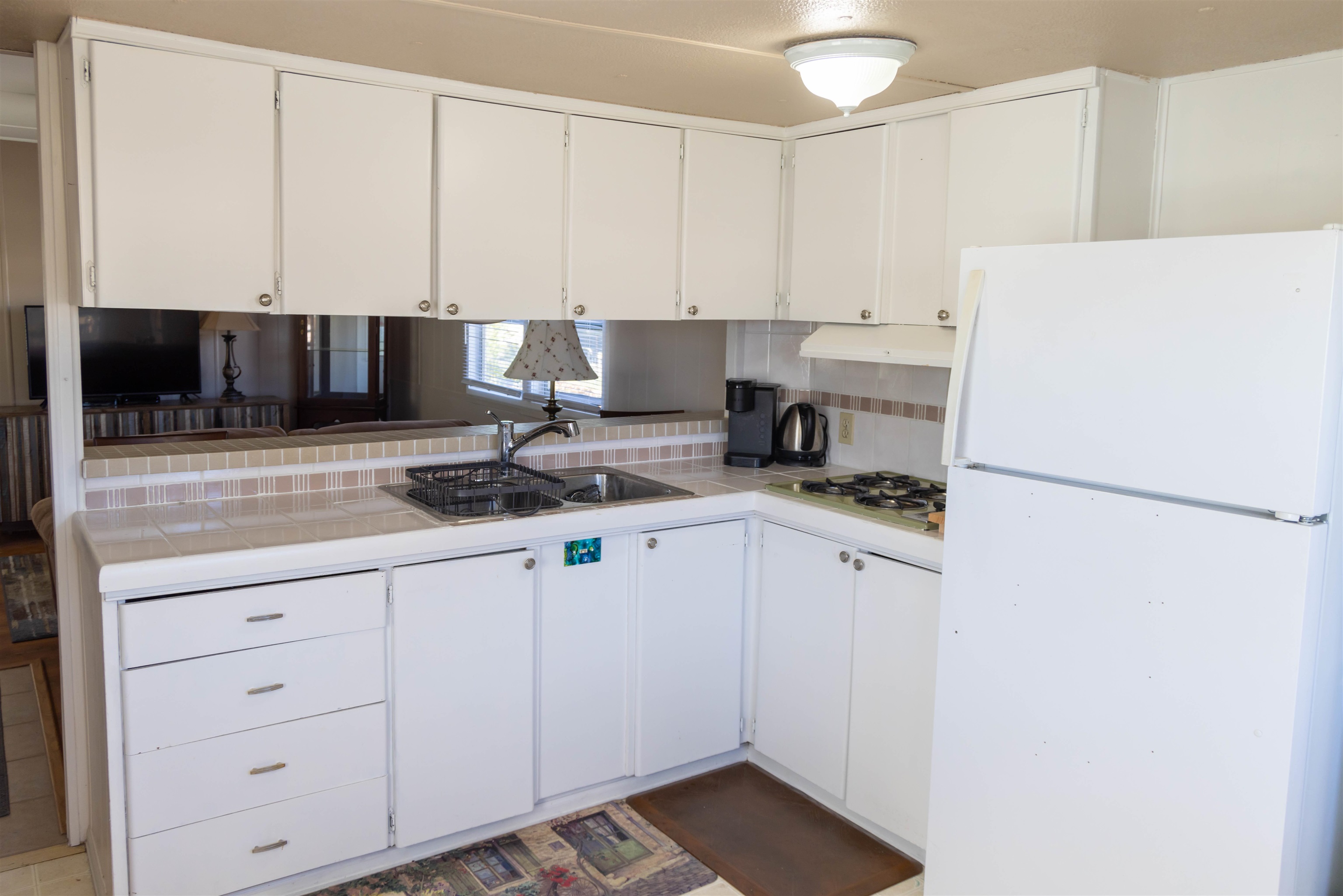 585-25 25 1/2 Road, Unit 232 Grand Junction, CO 81505 - Photo 7 of 40 a kitchen with a refrigerator sink and cabinets
