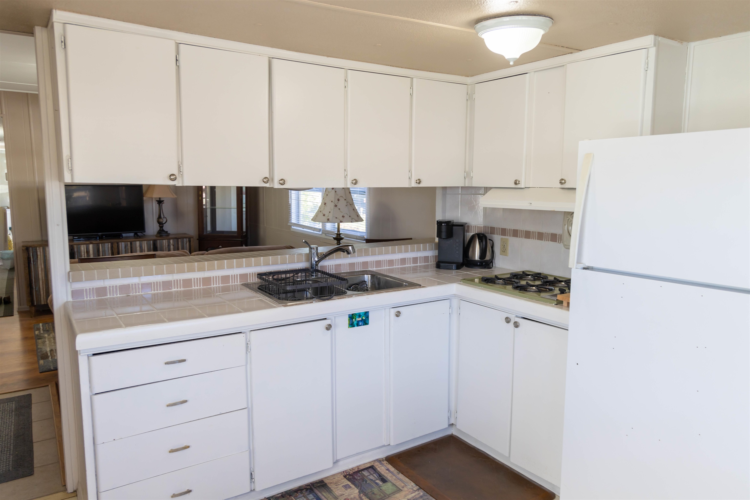 585-25 25 1/2 Road, Unit 232 Grand Junction, CO 81505 - Photo 9 of 40 a kitchen with a sink a stove and white cabinets