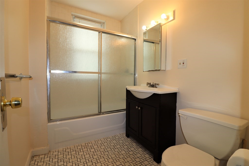 1427 Commonwealth Avenue, Unit 302 Boston, MA 02135 - Photo 11 of 12 a bathroom with a sink and a mirror
