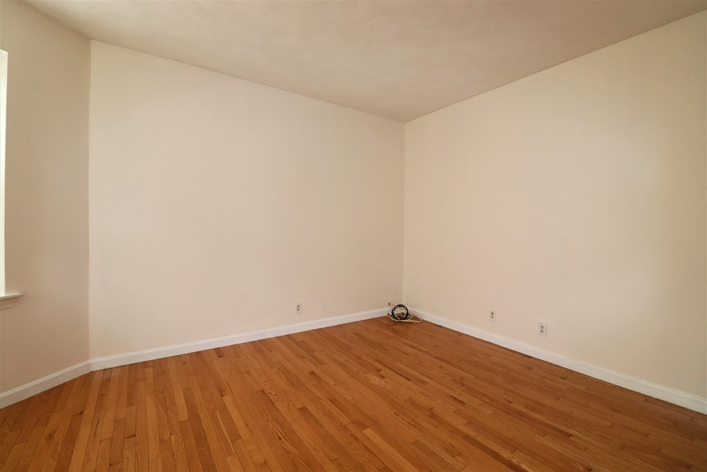 1427 Commonwealth Avenue, Unit 302 Boston, MA 02135 - Photo 6 of 12 a view of empty room with wooden floor