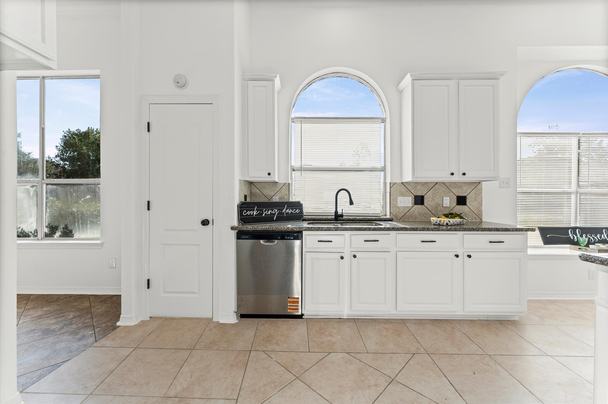 23827 Spring Dane Drive Spring, TX 77373 - Photo 12 of 36 a kitchen with granite countertop white cabinets and white appliances