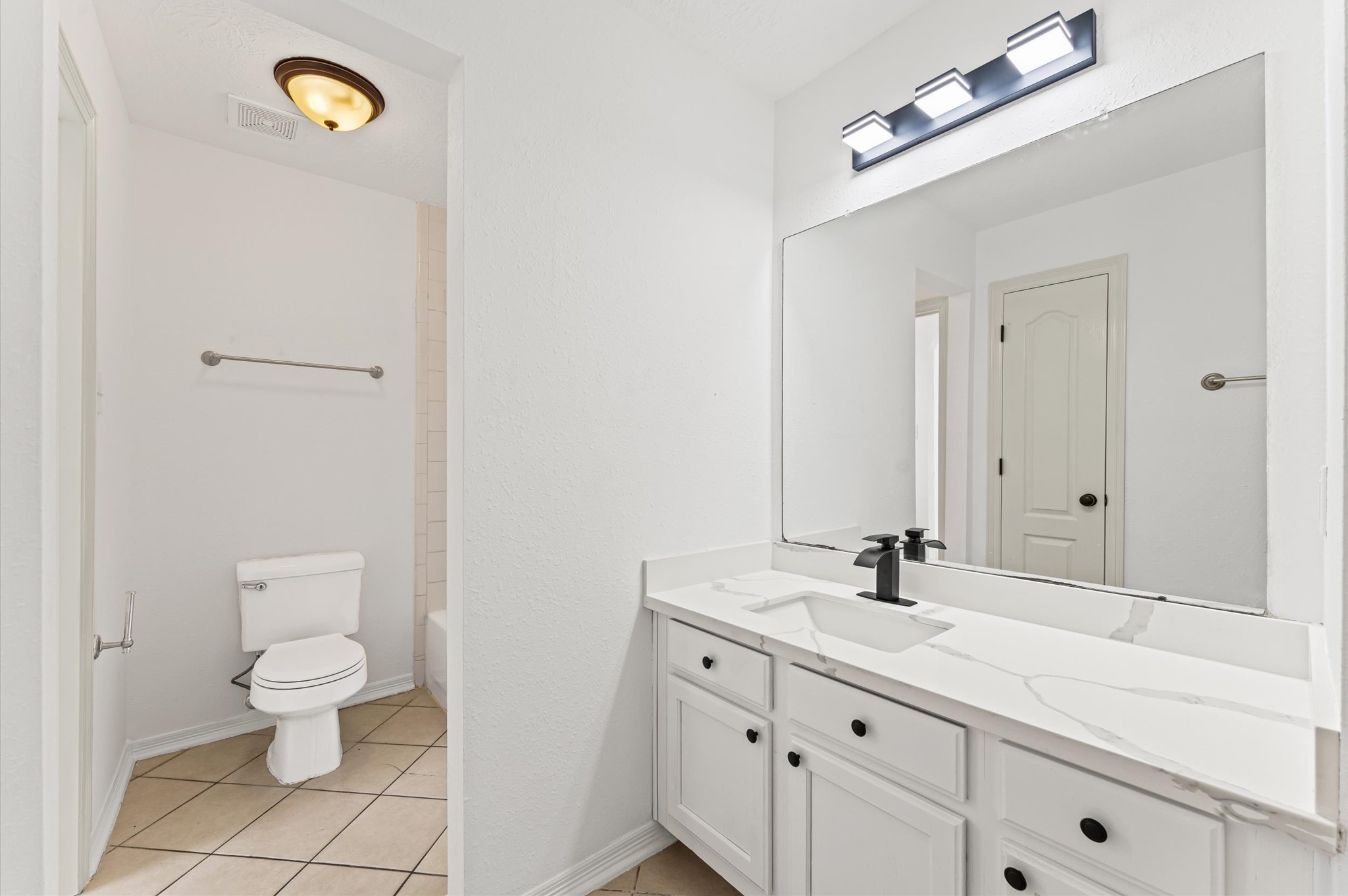 23827 Spring Dane Drive Spring, TX 77373 - Photo 29 of 36 a bathroom with a toilet sink and mirror