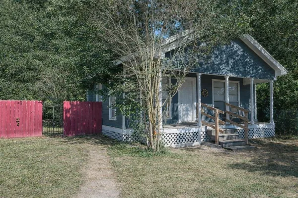a view of a chair and table in backyard