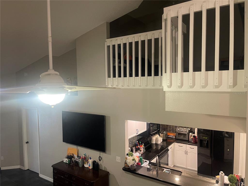 6980 Ulmerton Road, Unit 3G Largo, FL 33771 - Photo 12 of 52 a living room with furniture and a flat screen tv