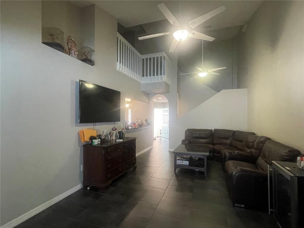 6980 Ulmerton Road, Unit 3G Largo, FL 33771 - Photo 13 of 52 a living room with furniture and a flat screen tv