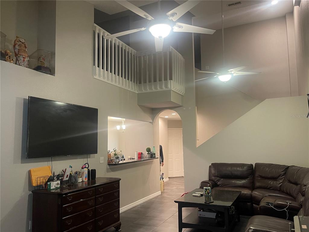 6980 Ulmerton Road, Unit 3G Largo, FL 33771 - Photo 14 of 52 a living room with furniture and a flat screen tv