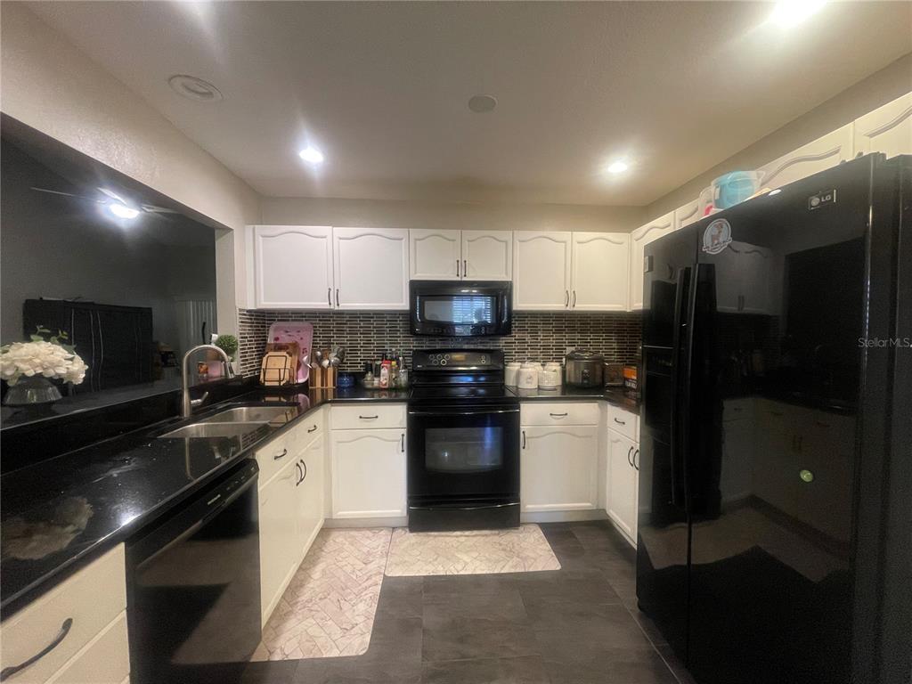 6980 Ulmerton Road, Unit 3G Largo, FL 33771 - Photo 16 of 52 a kitchen with a sink stainless steel appliances and cabinets