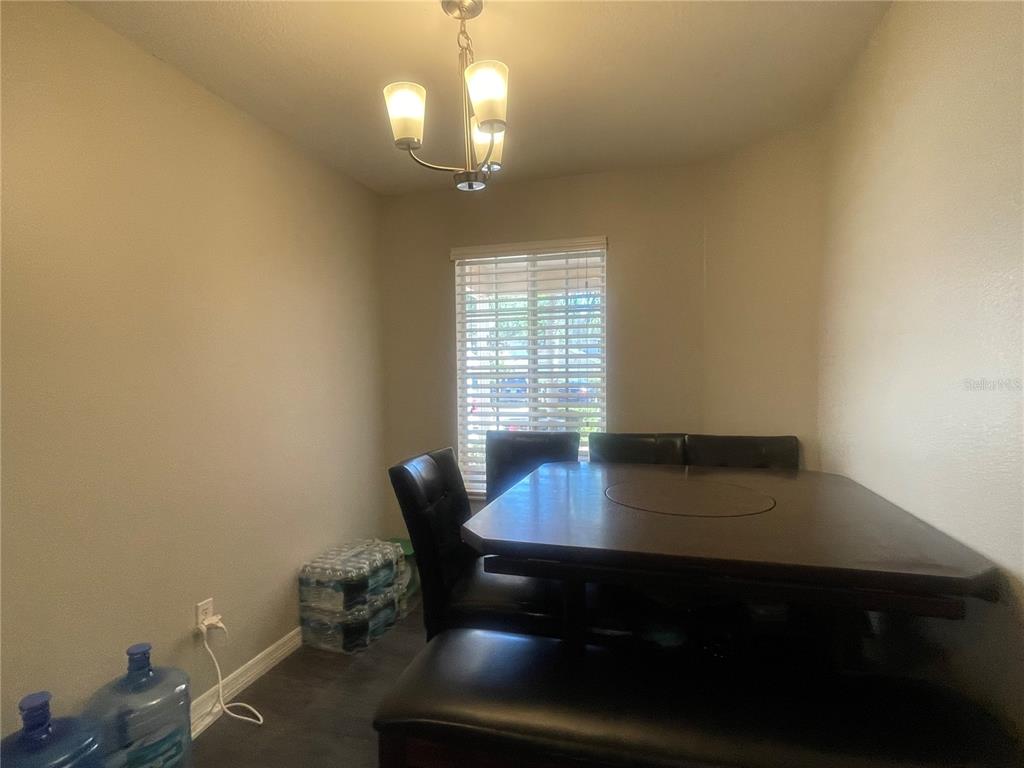 6980 Ulmerton Road, Unit 3G Largo, FL 33771 - Photo 17 of 52 a view of a dining room with furniture and wooden floor