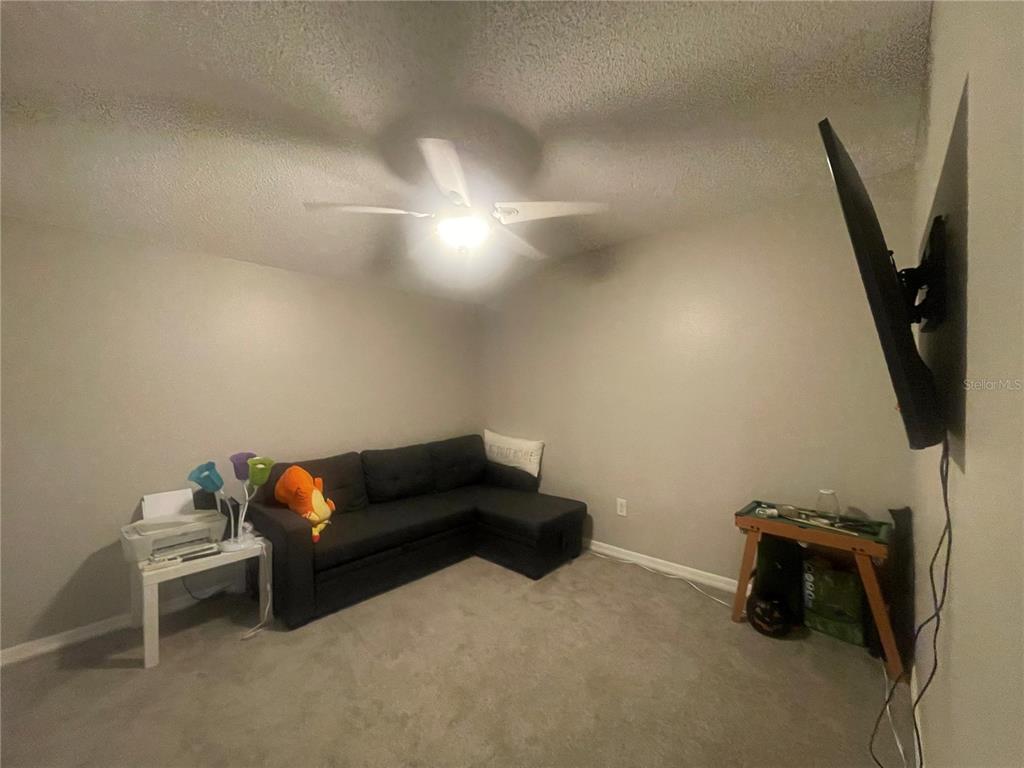 6980 Ulmerton Road, Unit 3G Largo, FL 33771 - Photo 18 of 52 a living room with furniture and a flat screen tv