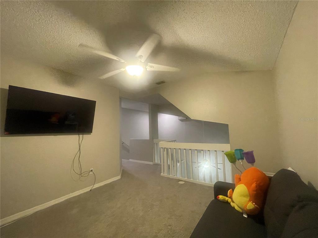 6980 Ulmerton Road, Unit 3G Largo, FL 33771 - Photo 19 of 52 a living room with furniture and a flat screen tv