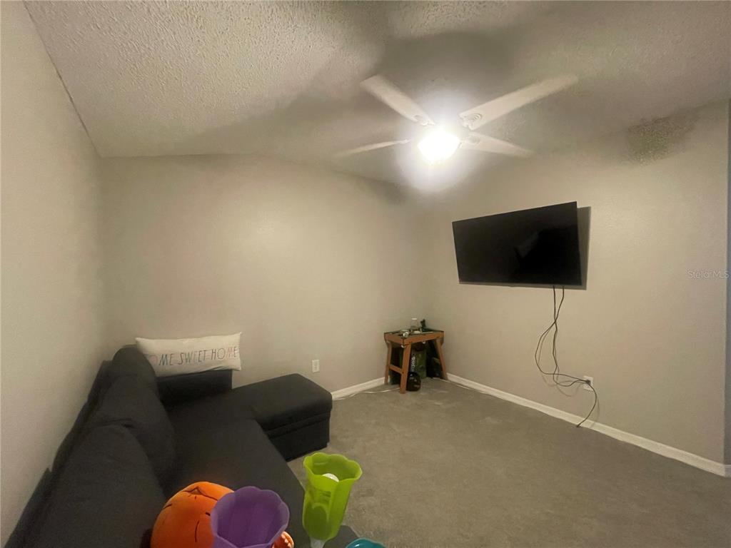 6980 Ulmerton Road, Unit 3G Largo, FL 33771 - Photo 20 of 52 a living room with furniture and a flat screen tv
