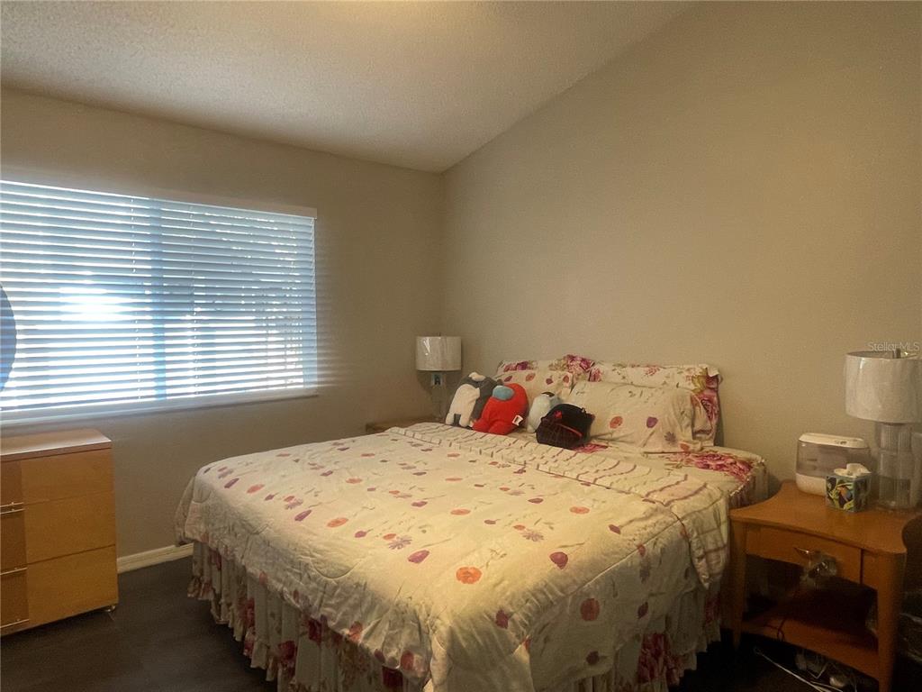 6980 Ulmerton Road, Unit 3G Largo, FL 33771 - Photo 22 of 52 a bedroom with a bed and a window